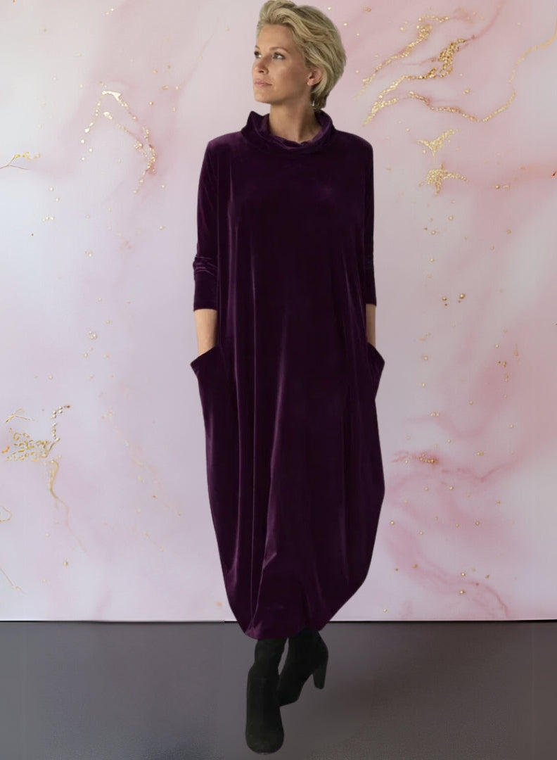 Rear view of the Leona velvet maxi dress, highlighting the graceful fall of the fabric and overall versatile design.