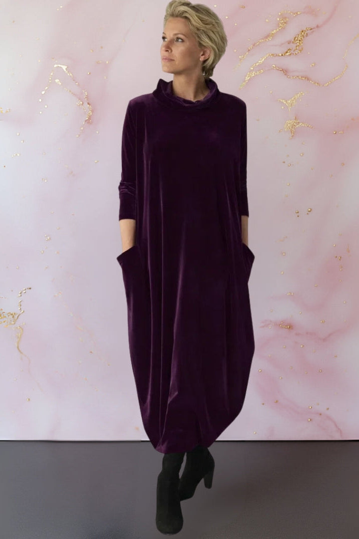 Rear view of the Leona velvet maxi dress, highlighting the graceful fall of the fabric and overall versatile design.