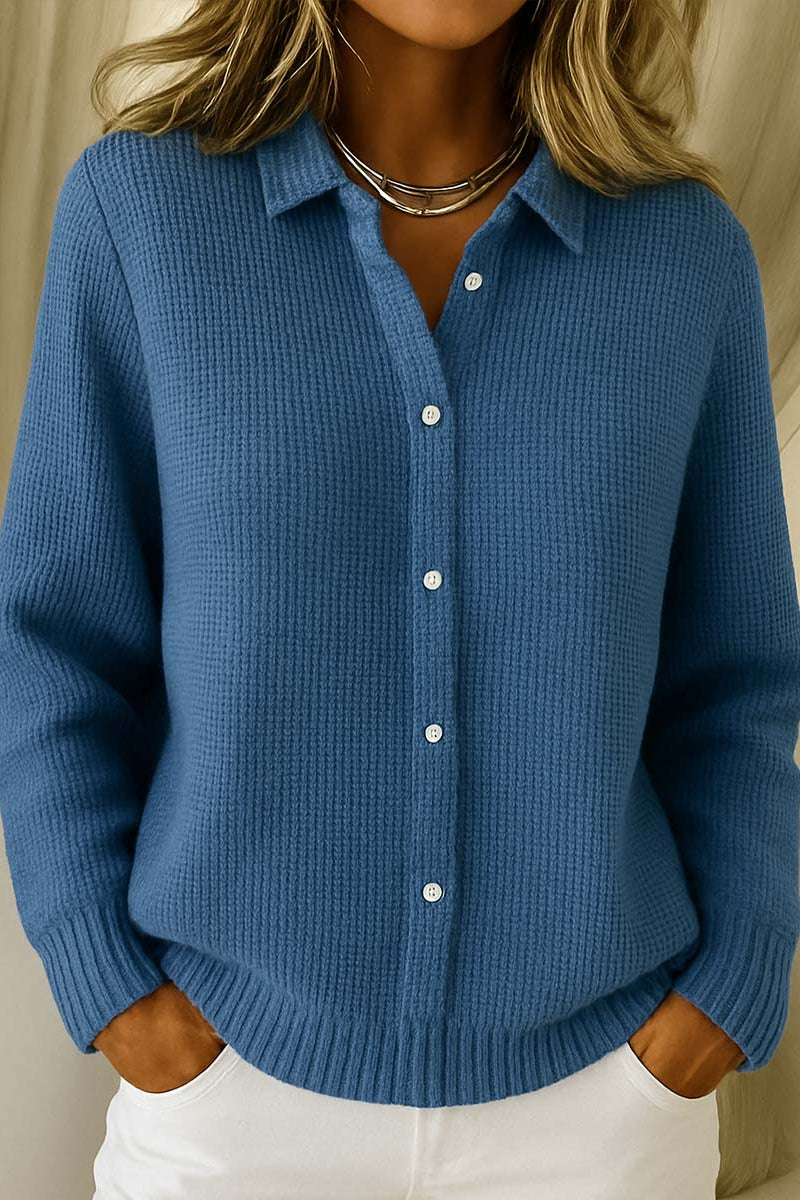 Detail of the fine knit texture and button closure on the Lila cardigan.