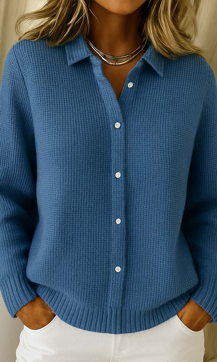 Detail of the fine knit texture and button closure on the Lila cardigan.