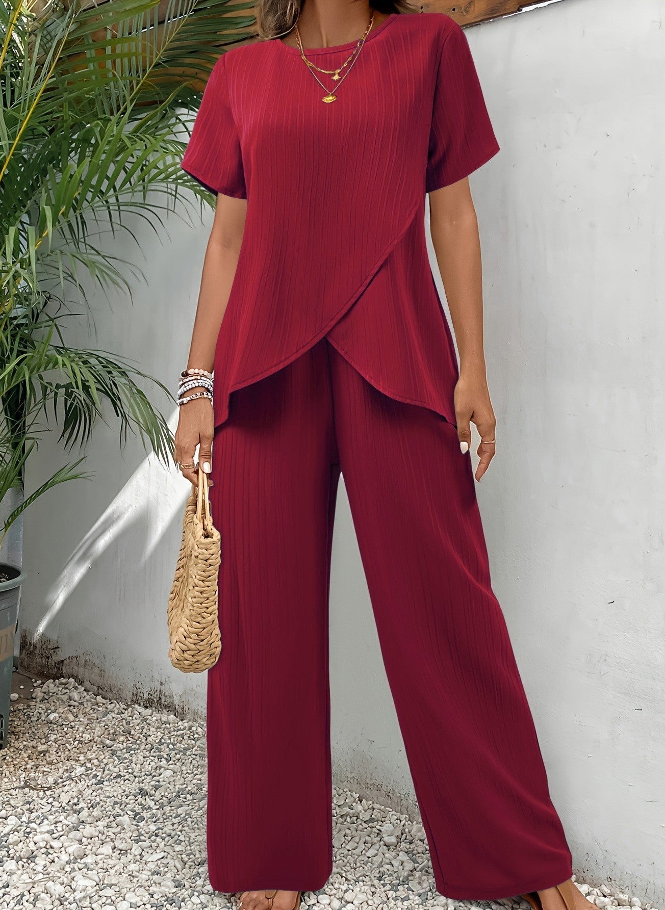 Side profile of a woman in green wide-leg pants, showcasing the flow and drape of the fabric.