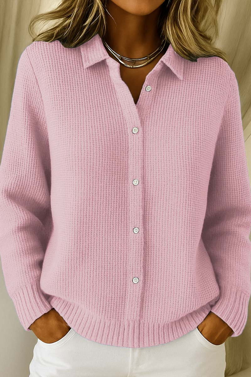 Woman wearing the Lila knit cardigan in pink, styled casually outdoors.