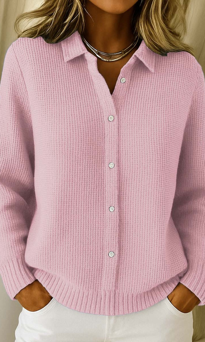 Woman wearing the Lila knit cardigan in pink, styled casually outdoors.