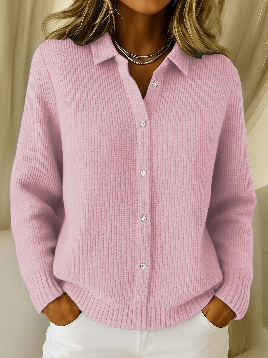 Woman wearing the Lila knit cardigan in pink, styled casually outdoors.