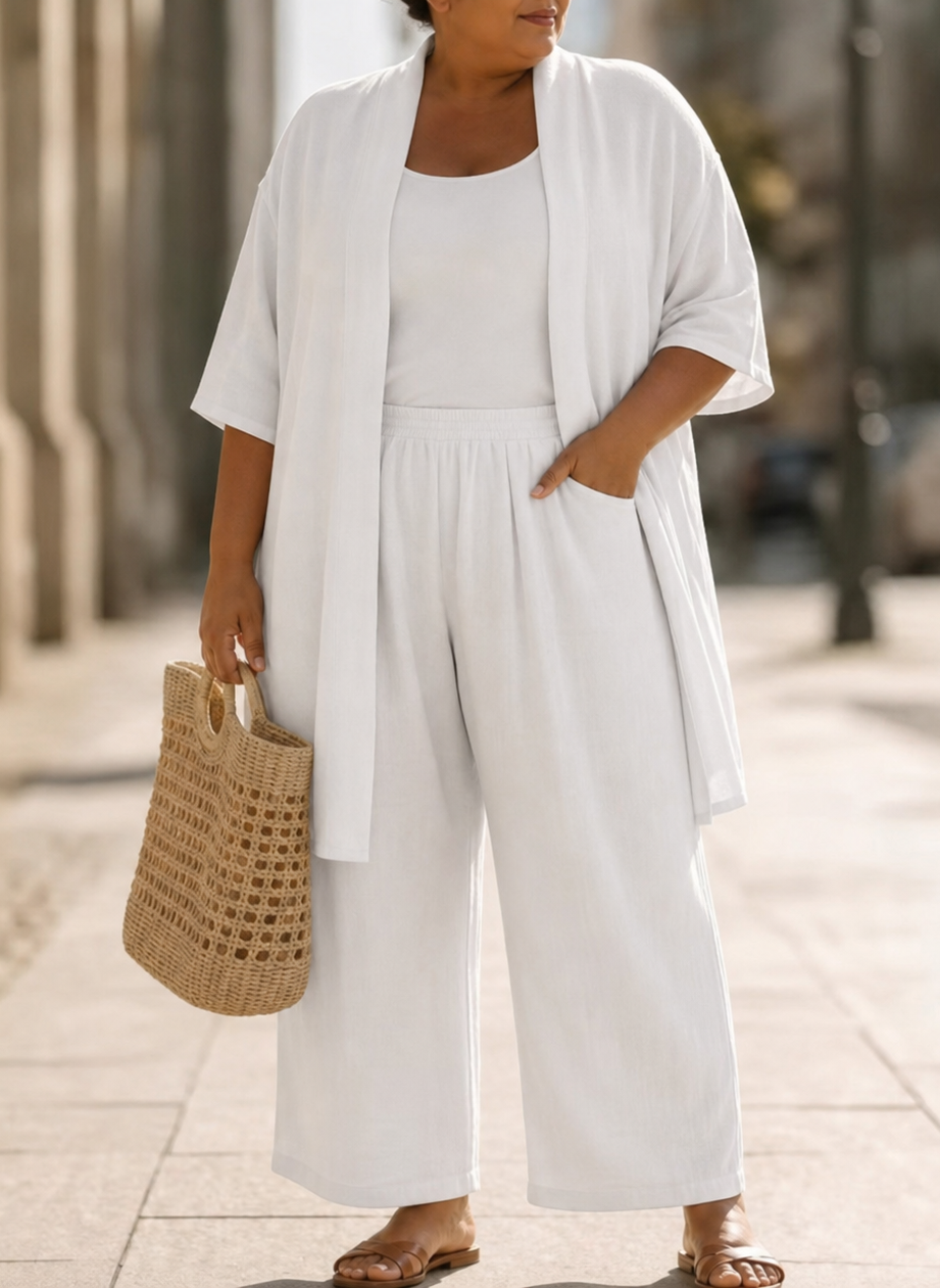 Side profile of a model wearing the Lila relaxed three-piece set in blue, illustrating the flowing silhouette of the wide-leg trousers.