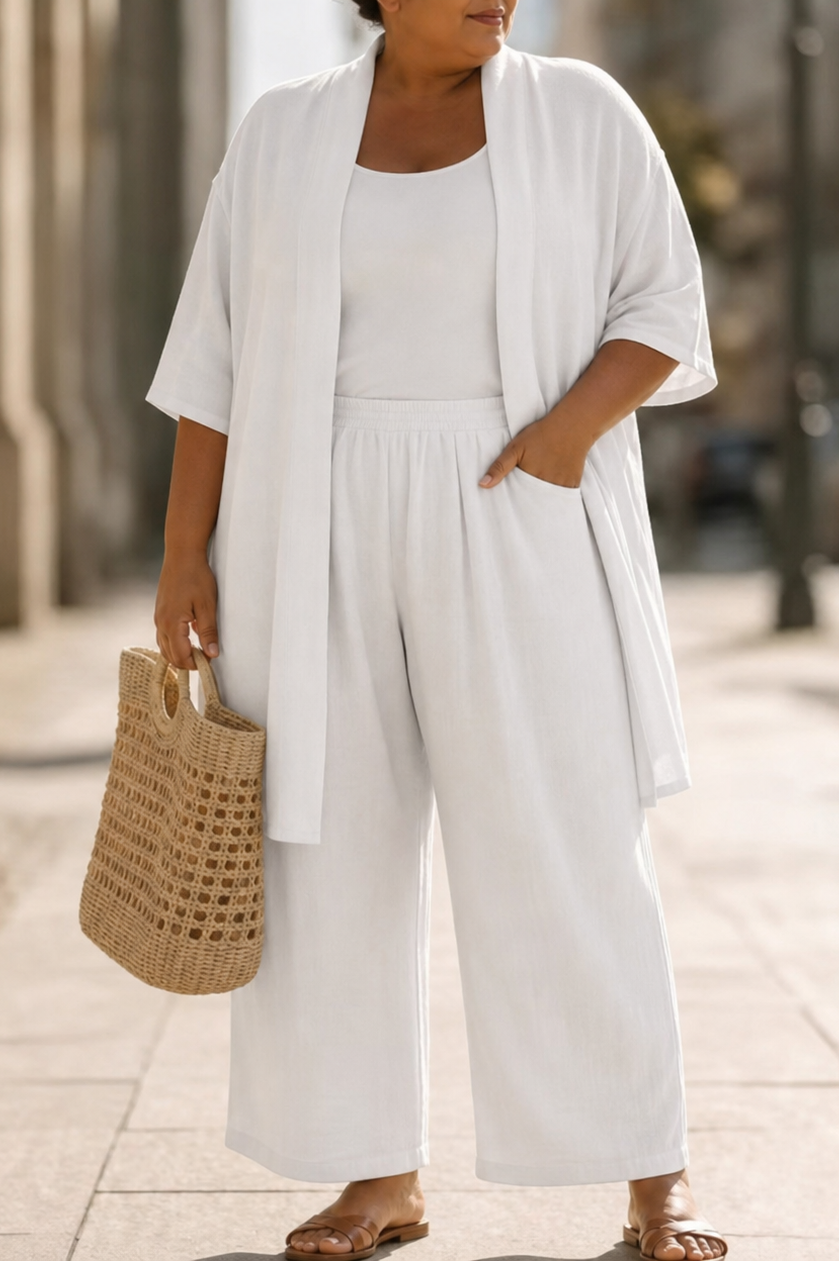Side profile of a model wearing the Lila relaxed three-piece set in blue, illustrating the flowing silhouette of the wide-leg trousers.