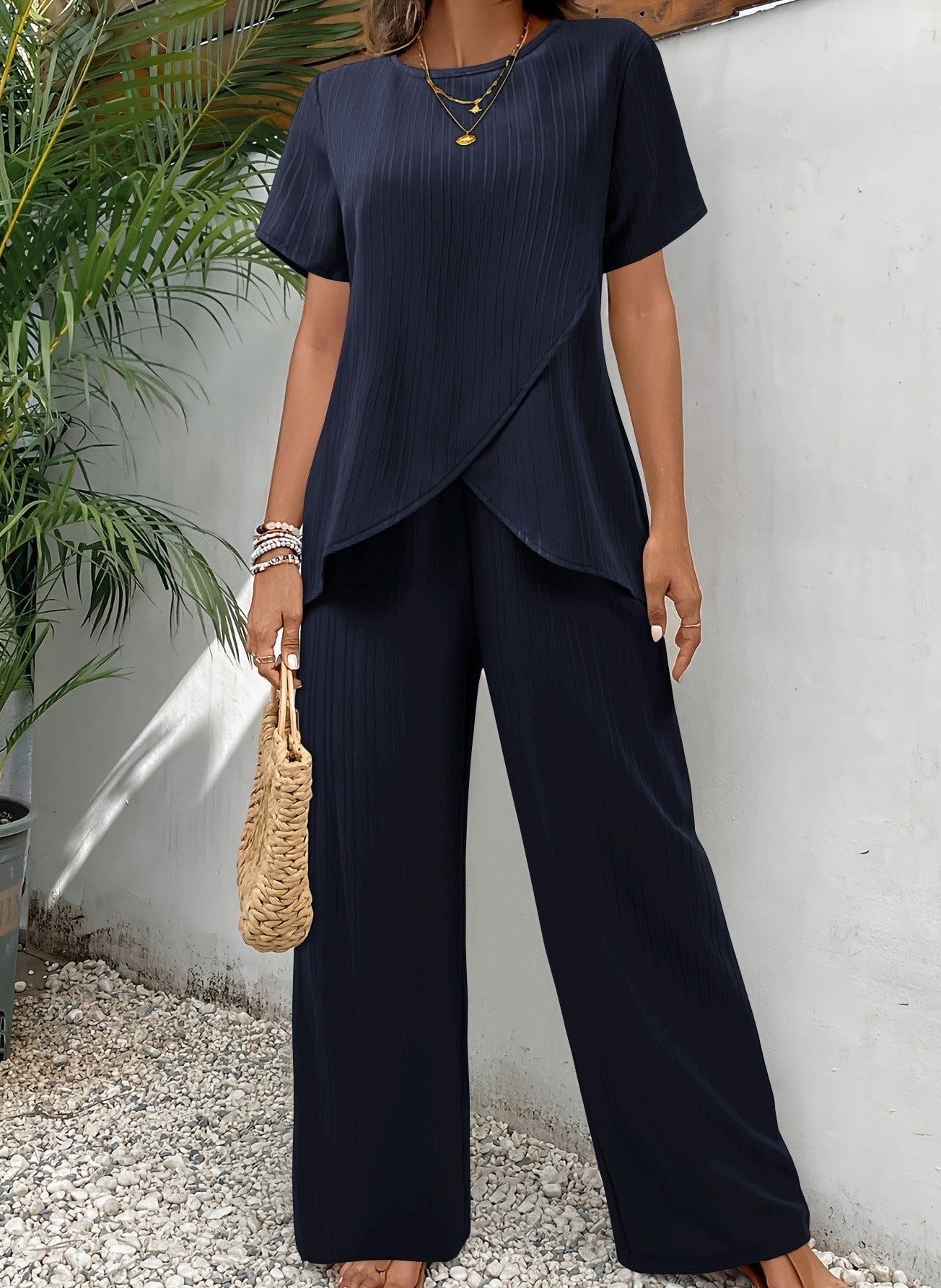 Woman walking in navy wide-leg pants, demonstrating freedom of movement and elegant stride.