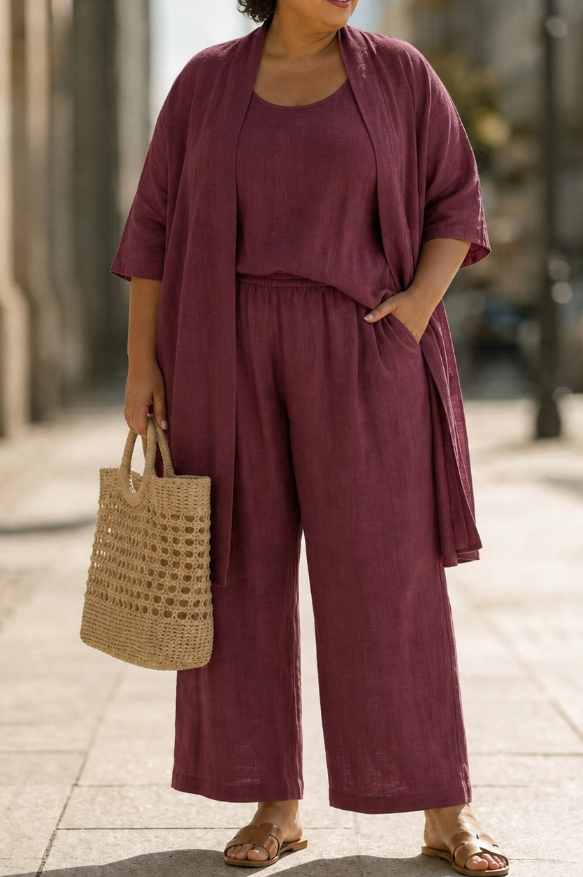 Lifestyle shot of a woman wearing the Lila relaxed three-piece set in black, styled with accessories for a chic urban look.