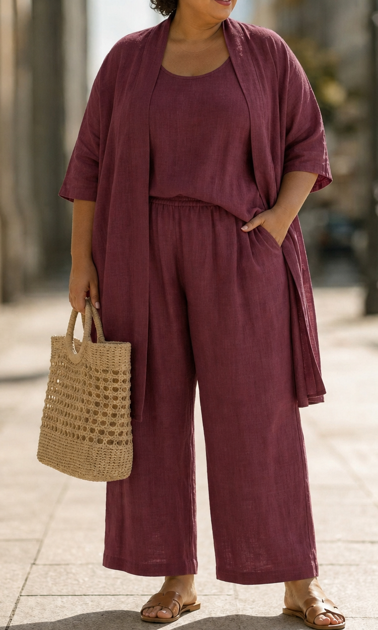 Lifestyle shot of a woman wearing the Lila relaxed three-piece set in black, styled with accessories for a chic urban look.