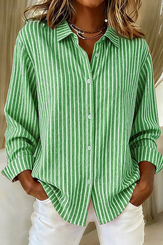 Side profile of a model wearing the green Linnea relaxed fit shirt, highlighting its loose drape and long sleeves.
