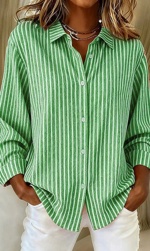 Side profile of a model wearing the green Linnea relaxed fit shirt, highlighting its loose drape and long sleeves.