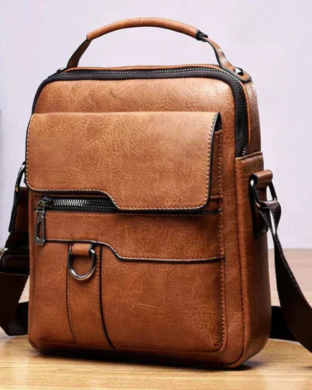 Close-up detail of the ecological leather texture on the Caleb shoulder bag, highlighting the water-resistant finish.