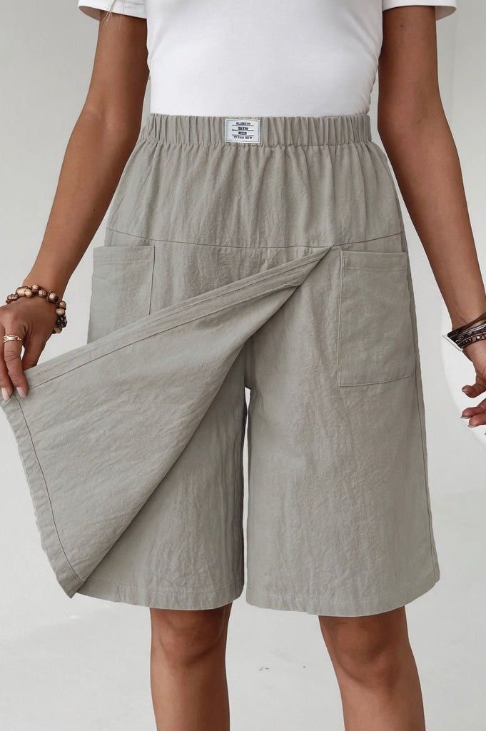 Front view of a model wearing the Lysandra versatile skort shorts in off-white, styled casually.