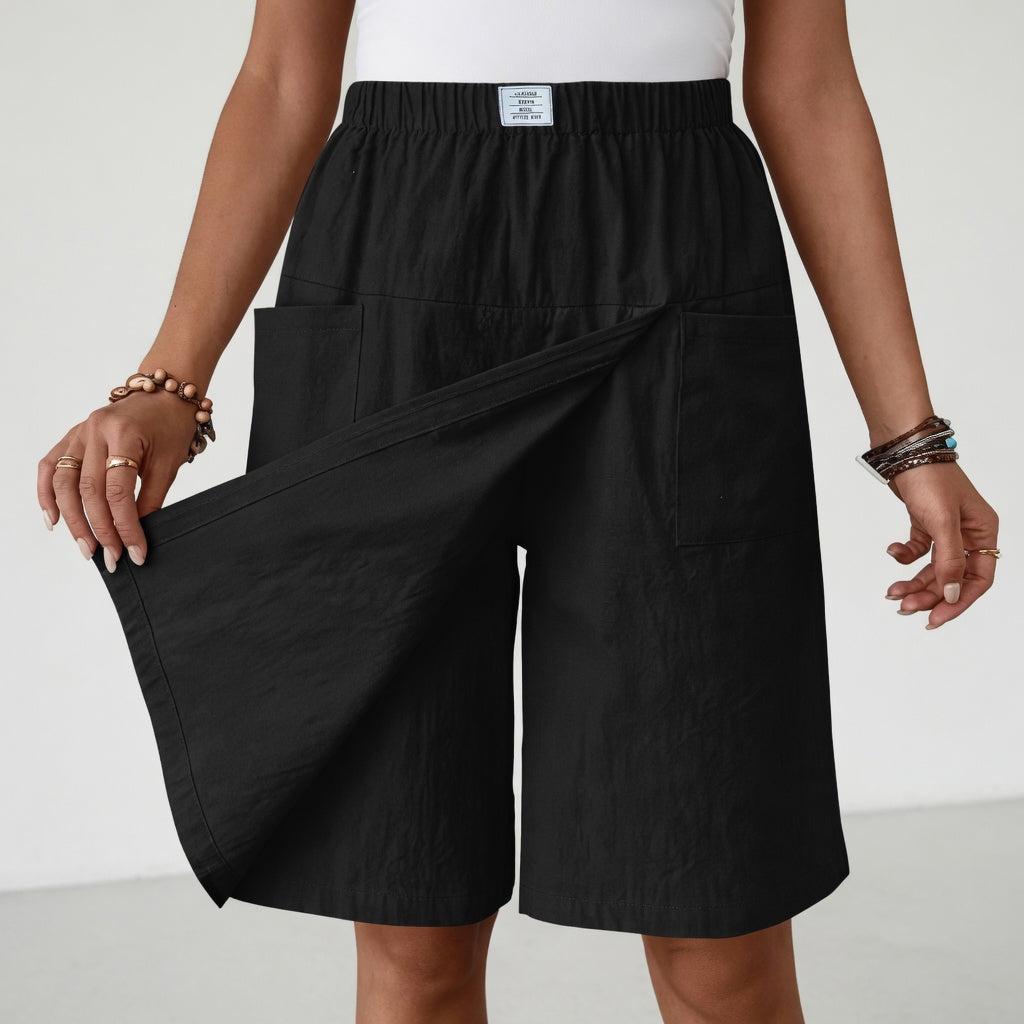 Close-up detail of the flattering wrap design and functional pockets on the dark blue skort shorts.