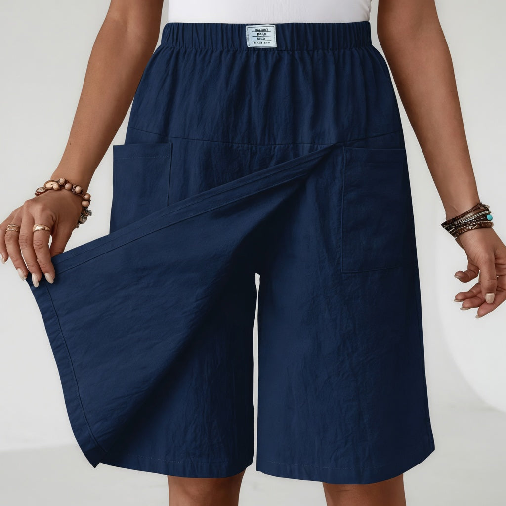 Lifestyle shot of a woman walking outdoors, showcasing the freedom of movement in the light grey skort shorts.