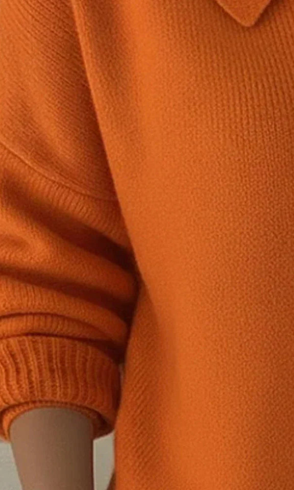 Back view of the Maeve classic button-up cardigan in orange, illustrating its harmonious line and relaxed silhouette.
