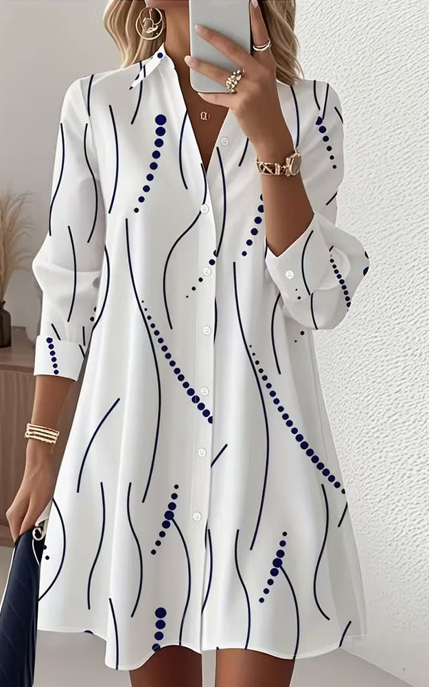 Front view of the Kira striped A-line dress in white, showcasing its wavy pattern and lapel collar.