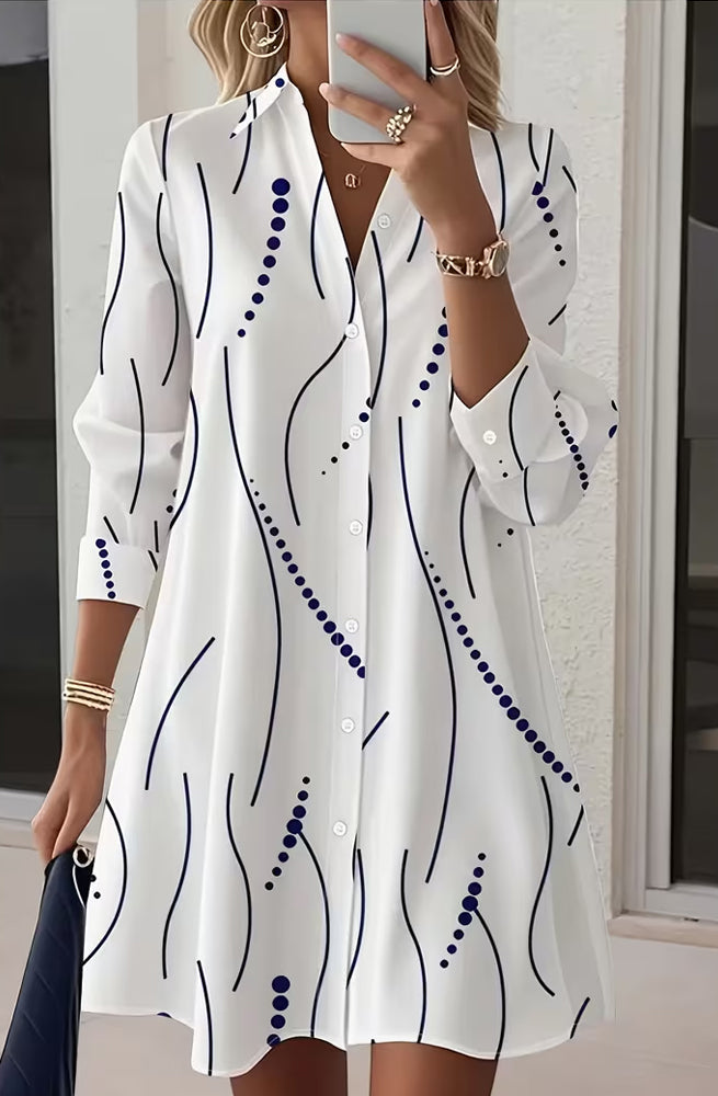 Side profile of a model wearing the white Kira striped A-line dress, highlighting the regular fit and above-knee length.