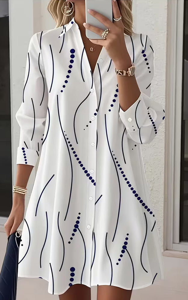 Side profile of a model wearing the white Kira striped A-line dress, highlighting the regular fit and above-knee length.