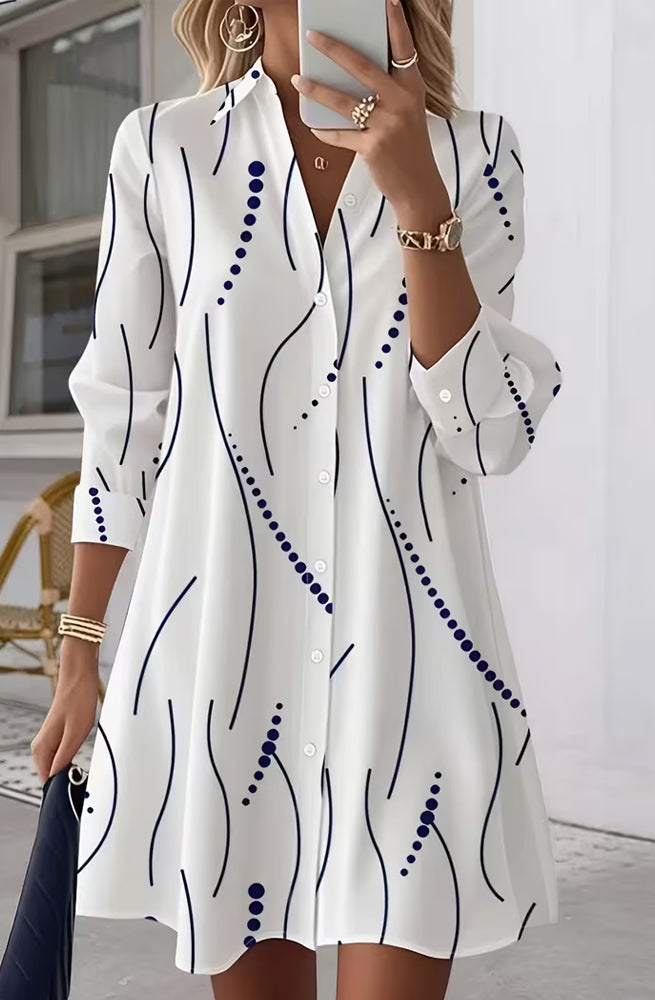 Back view of the Kira striped A-line dress, emphasizing the flow of the cotton blend fabric and overall silhouette.