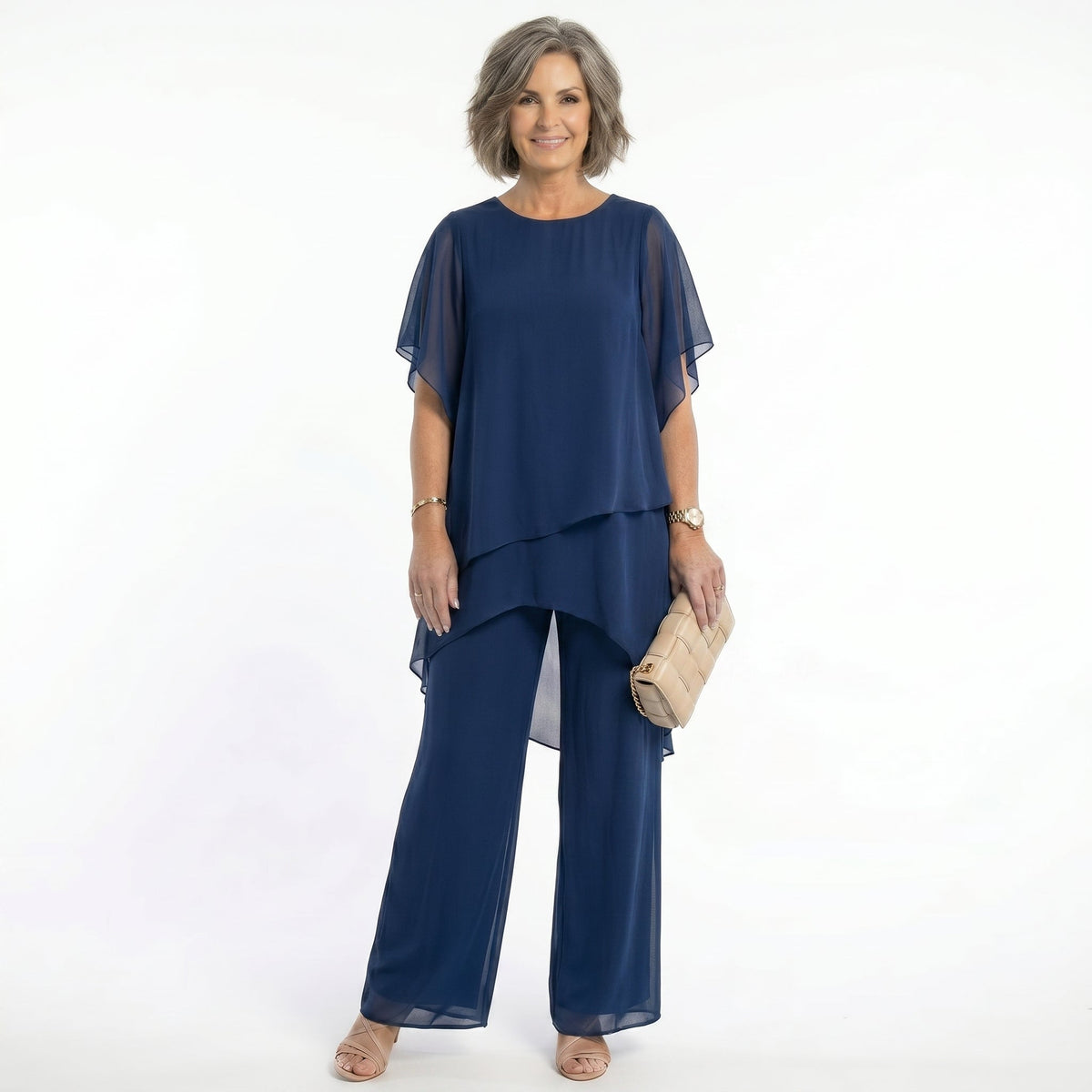 Front view of a model wearing a navy Tamsin tiered blouse, showcasing its elegant drape and short floaty sleeves.