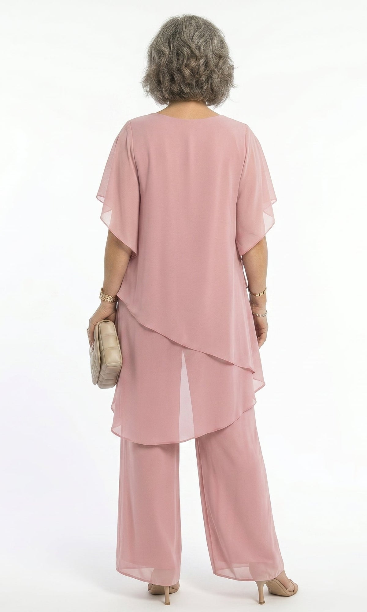 Close-up on the fabric texture and color vibrancy of the blush pink blouse, suggesting soft comfort.
