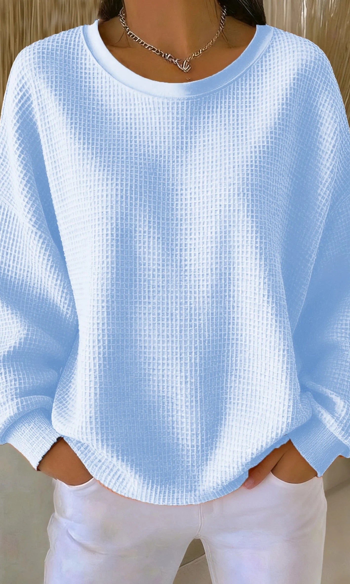 Front view of the Odette knit sweater in sky blue, showcasing its loose fit and textured knit.