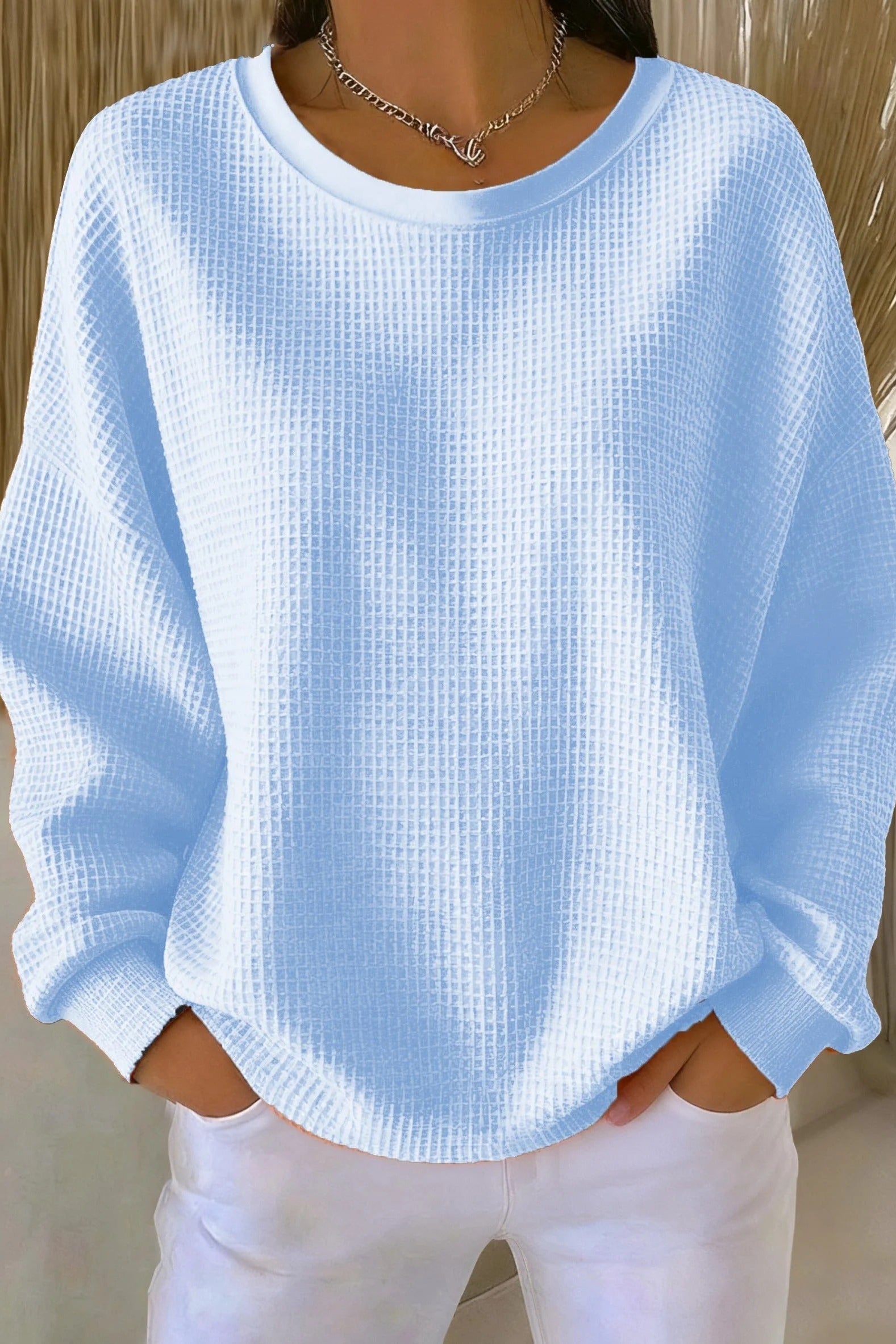 Front view of the Odette knit sweater in sky blue, showcasing its loose fit and textured knit.