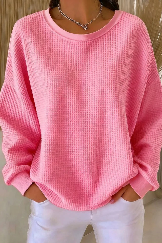 Overhead view of the Odette knit sweater in pink, highlighting its overall soft texture and design.