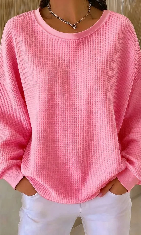 Overhead view of the Odette knit sweater in pink, highlighting its overall soft texture and design.