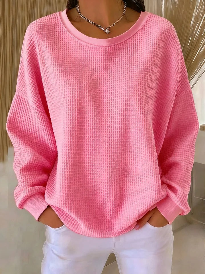Overhead view of the Odette knit sweater in pink, highlighting its overall soft texture and design.