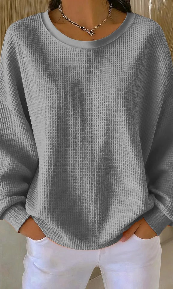 Close-up detail of the visible knit structure on the Odette sweater in gray, showing quality.