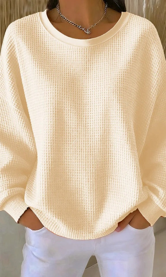 Model from behind in the Odette knit sweater in apricot, demonstrating its comfortable fit.