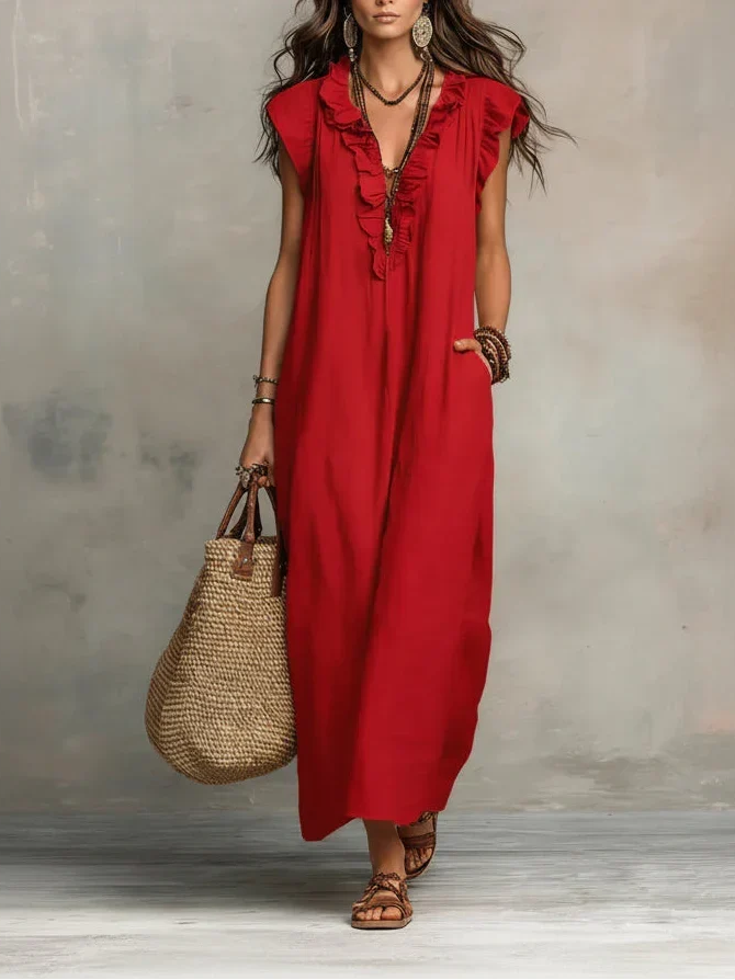 A woman's hand casually placed in one of the deep, functional pockets of the bohemian long maxi dress.