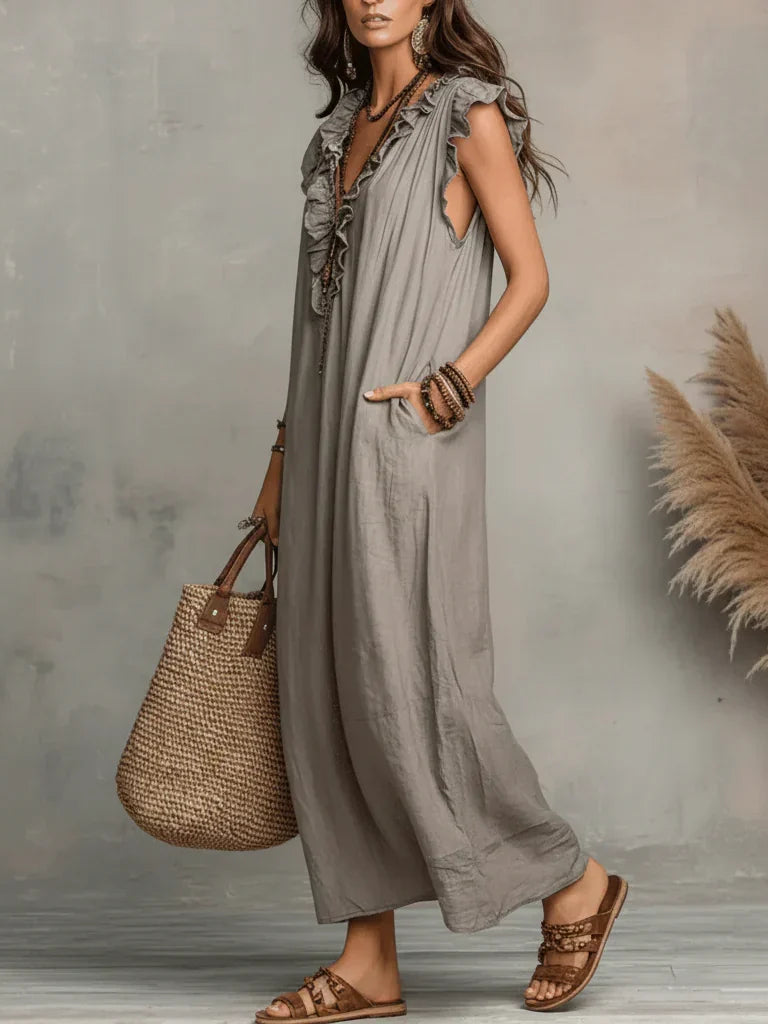 Detail of the fabric texture and subtle pattern of the Saskia long maxi dress, showing its quality.