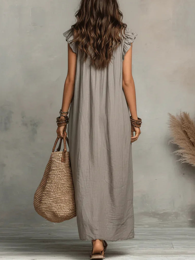 A woman twirling gently, emphasizing the free-flowing nature of the bohemian long maxi dress.