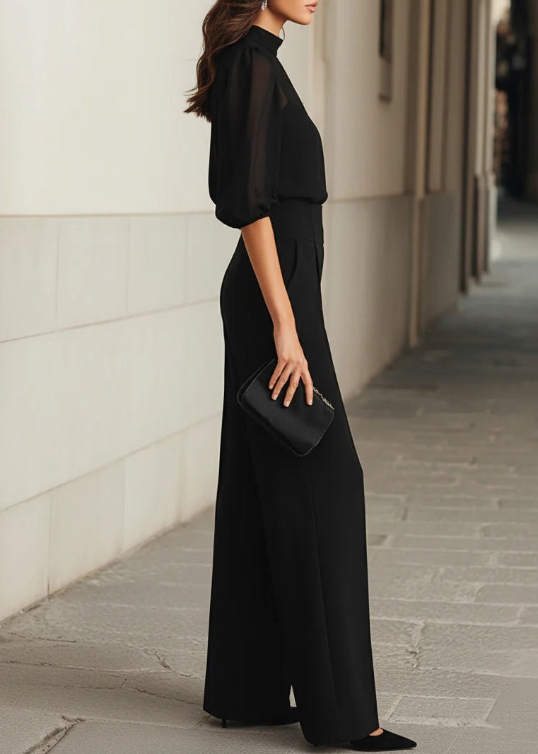Side profile of a woman wearing the elegant Romy three-piece set, illustrating the flowing drape of the wide-leg trousers.