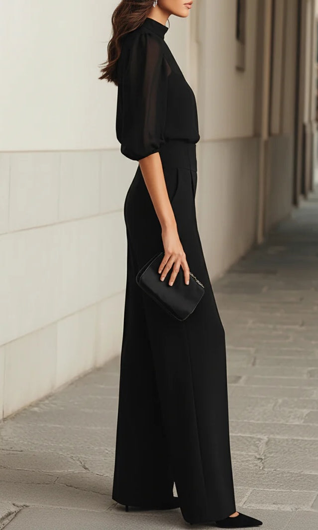Side profile of a woman wearing the elegant Romy three-piece set, illustrating the flowing drape of the wide-leg trousers.
