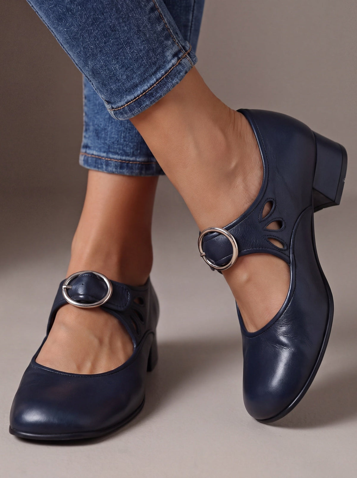 Side profile of a navy blue Mary Jane shoe, emphasizing the stable low heel and smooth finish for confident steps.