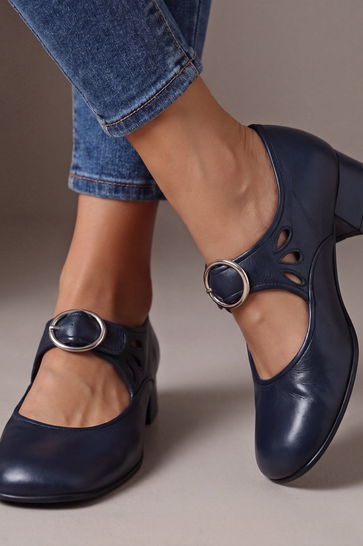 Side profile of a navy blue Mary Jane shoe, emphasizing the stable low heel and smooth finish for confident steps.
