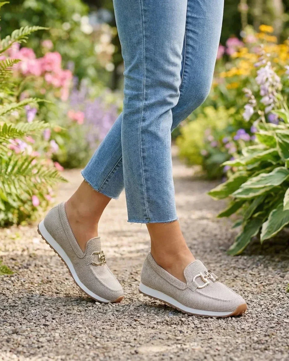 Model wearing beige orthopedic pants in a casual setting, illustrating their versatility and style.