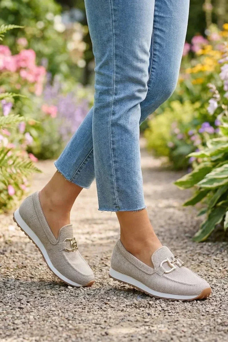 Model wearing beige orthopedic pants in a casual setting, illustrating their versatility and style.