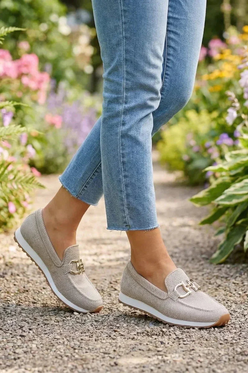 Model wearing beige orthopedic pants in a casual setting, illustrating their versatility and style.