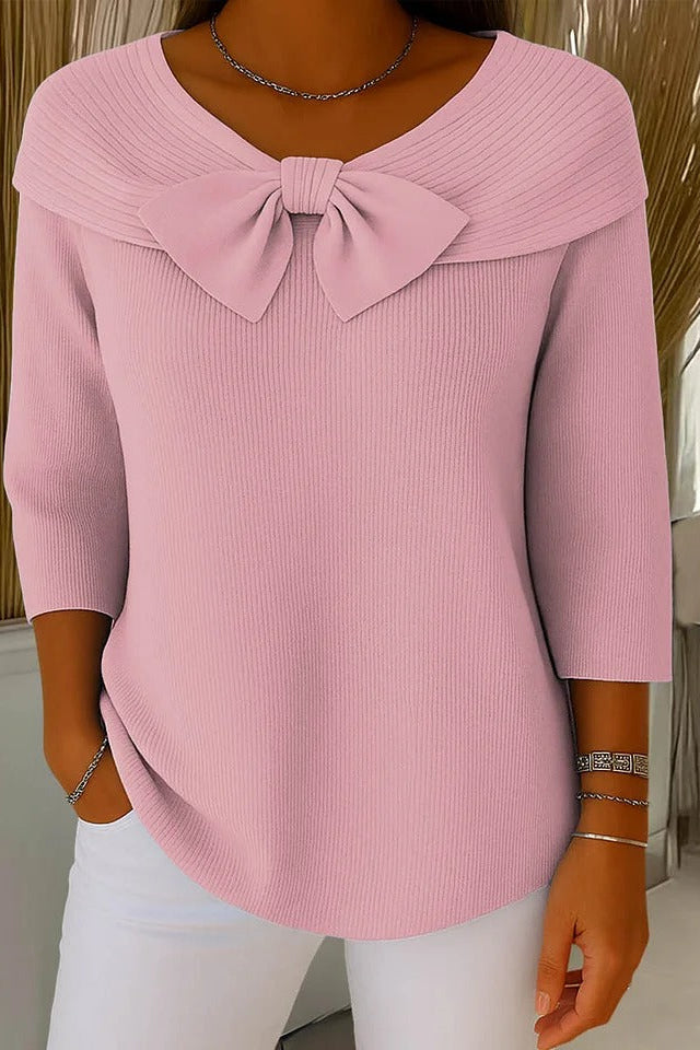 Side profile of a model wearing the Soraya relaxed knit tunic, highlighting the natural drape of the garment and moderate sleeve length.