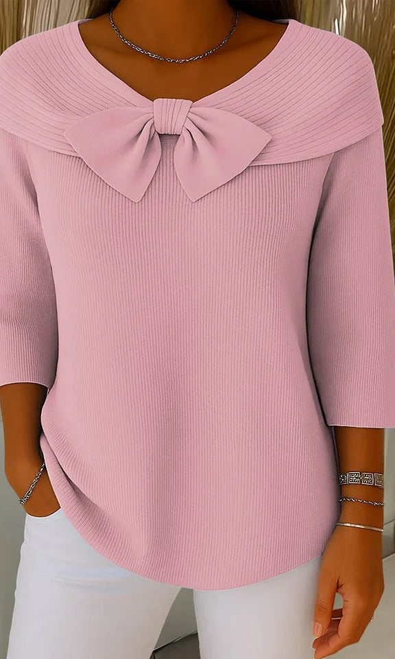 Side profile of a model wearing the Soraya relaxed knit tunic, highlighting the natural drape of the garment and moderate sleeve length.