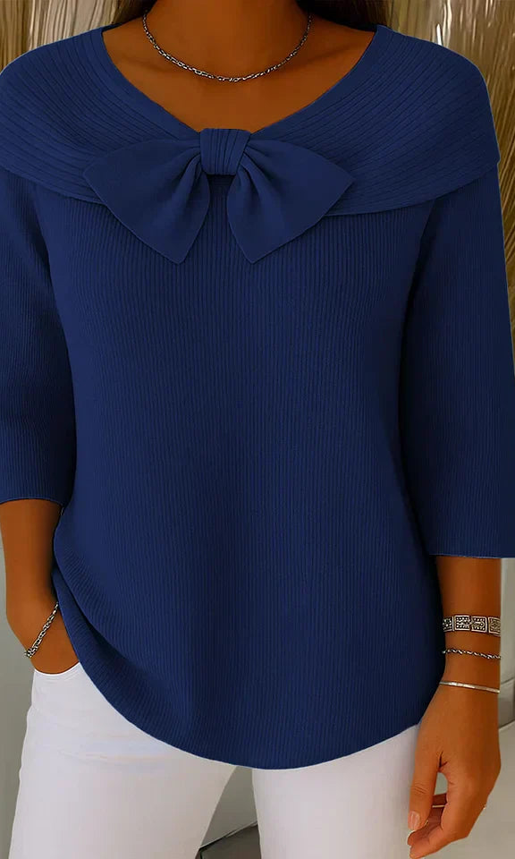 Lifestyle image of a woman wearing the Soraya relaxed knit tunic outdoors, illustrating its versatility for everyday activities.