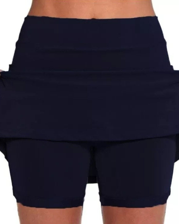 Side view of the light gray active skort, illustrating the short underlayer and overall athletic look.