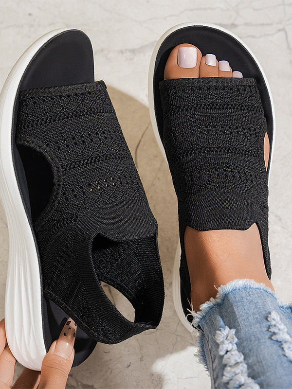 Side profile of beige knit platform sandals, highlighting the supportive platform and flexible design.