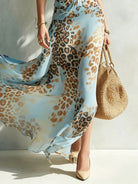 Elysia glamorous animal print maxi dress in red, captured in a full-length studio shot, showcasing vibrant tones.
