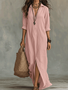 Detailed shot of the button-front closure on a blue long sleeve maxi dress, showing adjustability.